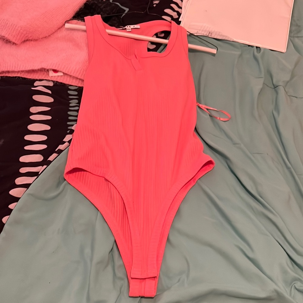 A peach body suit
